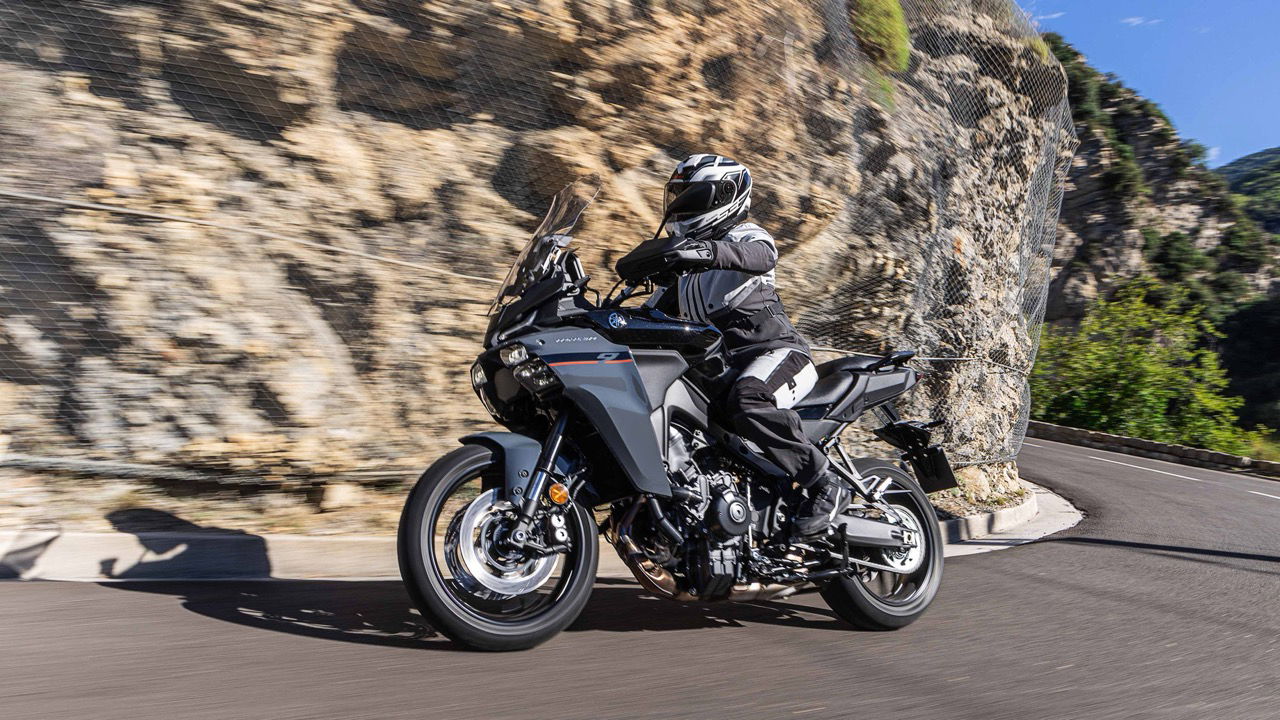 The Tracer 9 GT being ridden on a mountain road